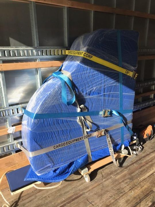 Piano wrapped in moving pads and strapped for transport (Piano) by Affordable Moving Solutions of Ohio